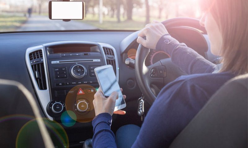 A third of motorists are still using their phones behind the wheel.