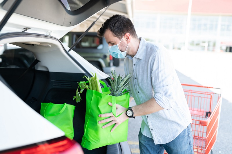 Man loading car with groceries