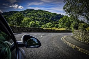 Car on sunny road in Lake District