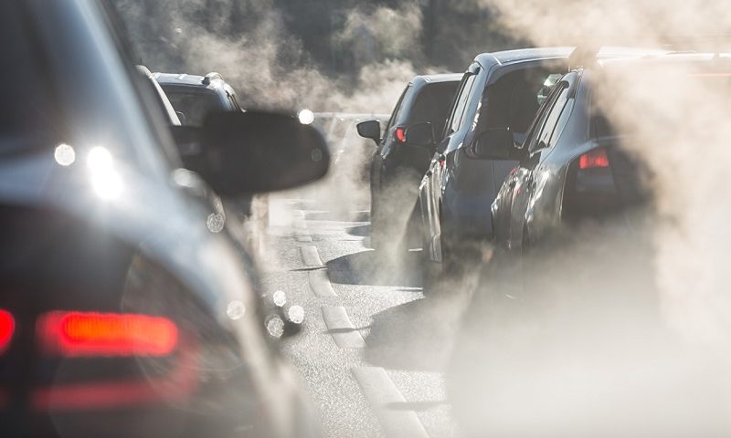 Traffic jam with cars surrounded by steam from exhaust pipes