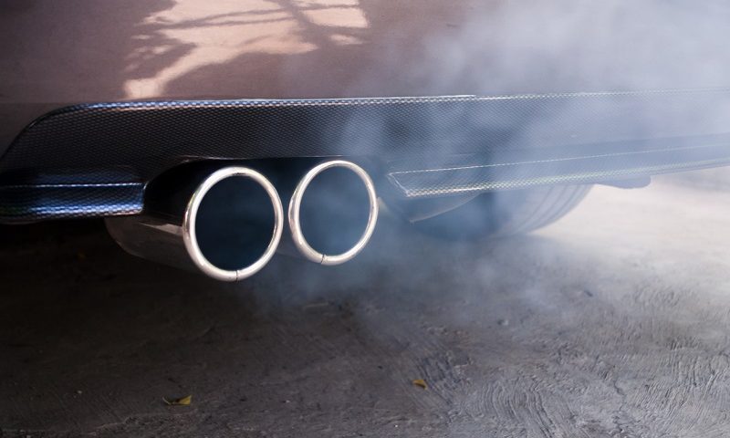 Smoke emissions from exhaust pipe in car