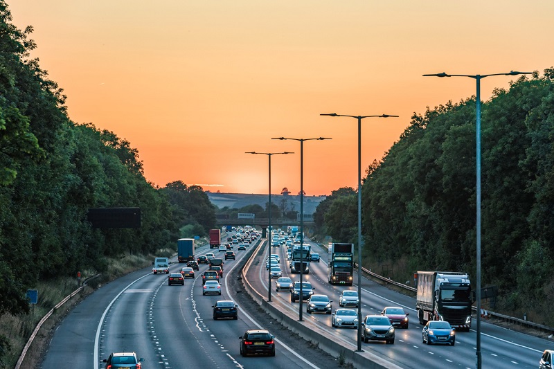 Cars driving on the motorway during sunset.
