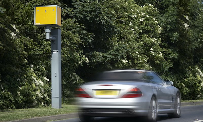 Car driving past a speed camera on the motorway