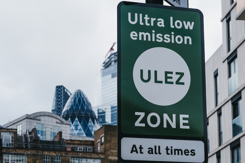 A green ULEZ sign on a London road