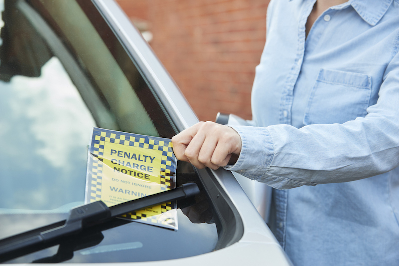 Parking ticket being left on car windscreen