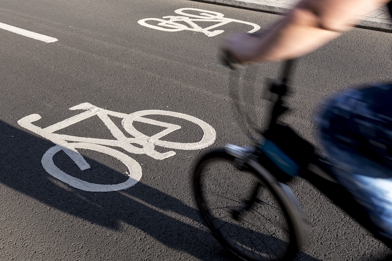 A person riding a bike in a cycle lane