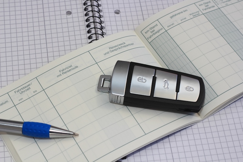 A blank logbook with a car key on top